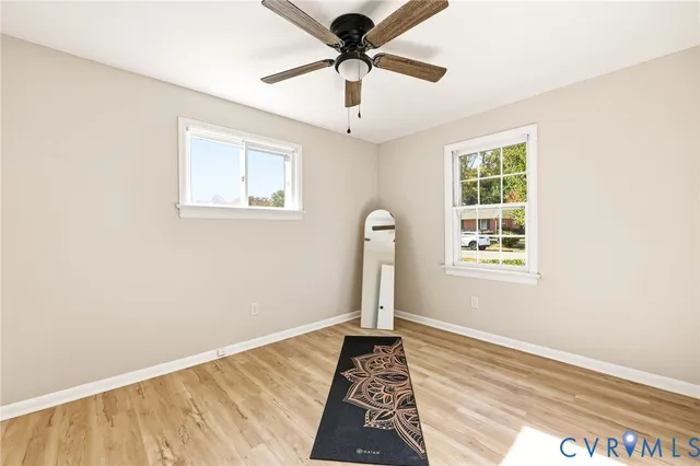 a view of a room with window and hardwood floor