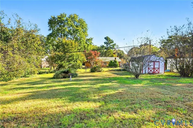a swimming pool with outdoor seating and yard