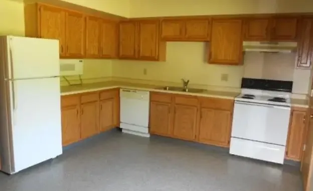 a kitchen with a sink a stove and refrigerator