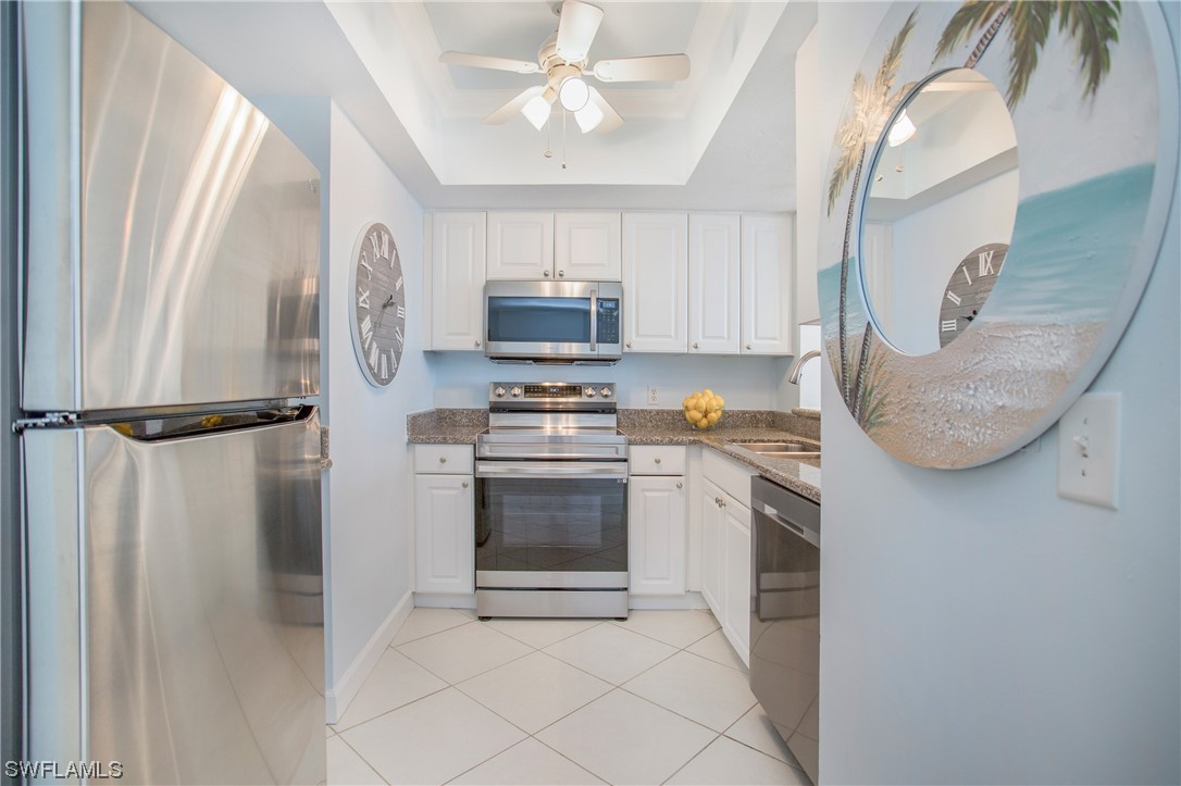 1920 Virginia Avenue, Unit 102 Fort Myers, FL 33901 - Photo 3 of 11 a kitchen with stainless steel appliances granite countertop a refrigerator a stove and a sink