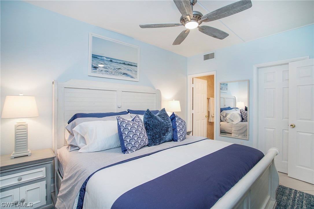 1920 Virginia Avenue, Unit 102 Fort Myers, FL 33901 - Photo 4 of 11 a bedroom with a bed and a chandelier