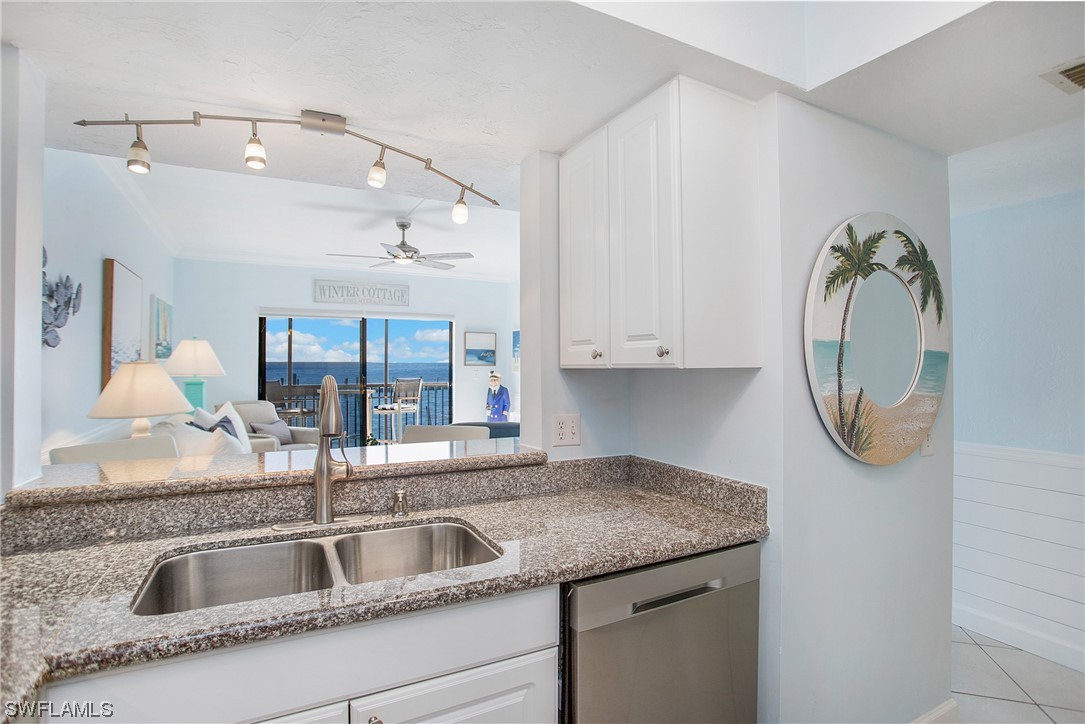 1920 Virginia Avenue, Unit 102 Fort Myers, FL 33901 - Photo 5 of 11 a kitchen with a sink and a mirror