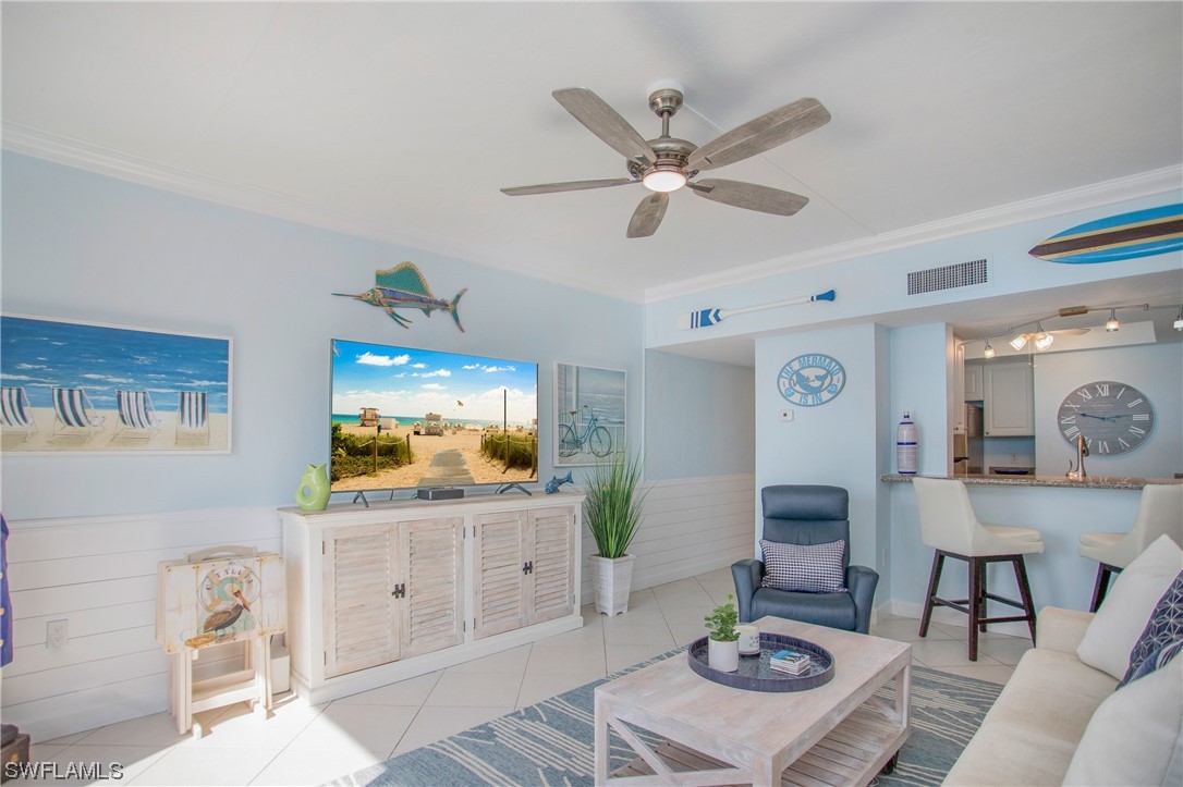1920 Virginia Avenue, Unit 102 Fort Myers, FL 33901 - Photo 8 of 11 a living room with furniture and a flat screen tv