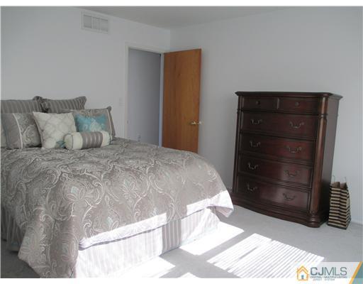 44 Brookside Road Edison, NJ 08817 - Photo 14 of 20 a large bed sitting in a bedroom and dresser