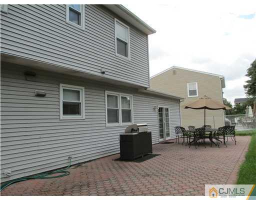 44 Brookside Road Edison, NJ 08817 - Photo 3 of 20 a backyard of a house with table and chairs