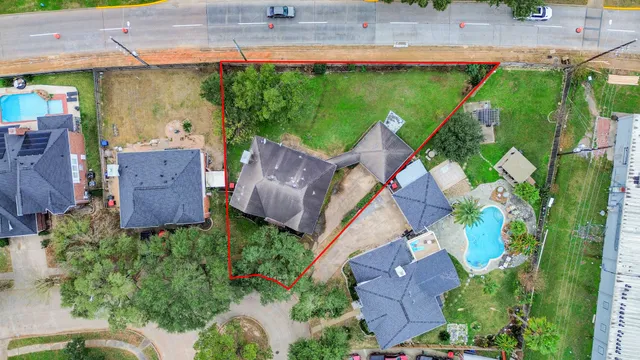 an aerial view of a house with a garden and outdoor seating