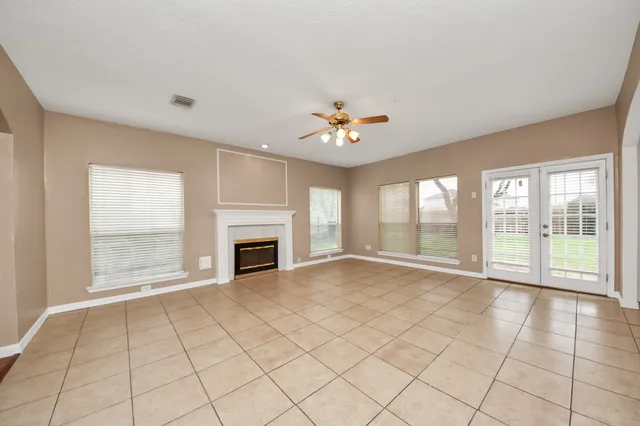 a view of an empty room with a fireplace and a large window
