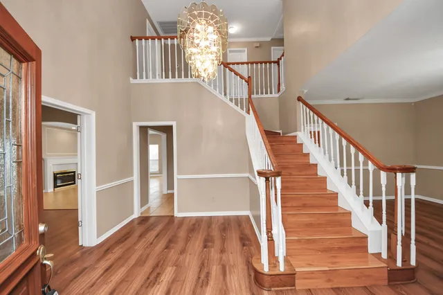 a view of entryway and hall with wooden floor