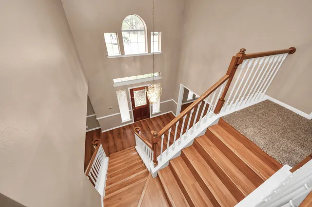 a view of entryway and hall with wooden floor