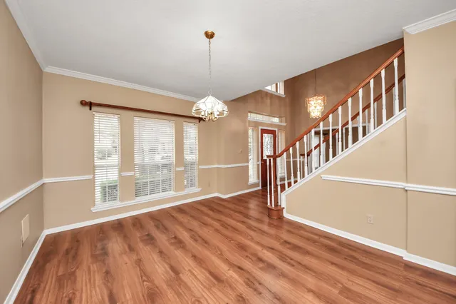 a view of an entryway with wooden floor