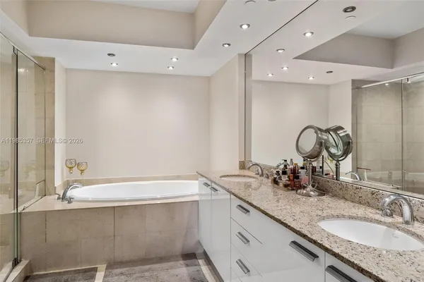 a bathroom with a granite countertop sink mirror and double