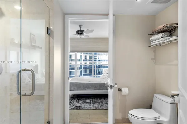 a bathroom with a sink toilet and shower