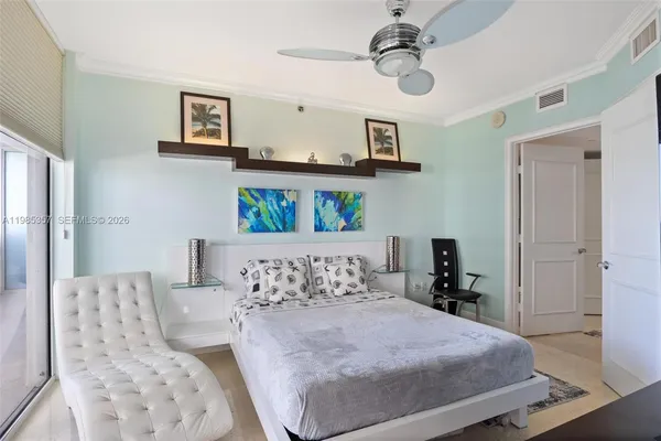 a bedroom with a bed a couch and potted plant