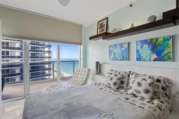 a view of a livingroom with wooden floor and furniture