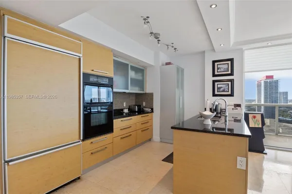 a kitchen with stainless steel appliances a refrigerator and a stove top oven