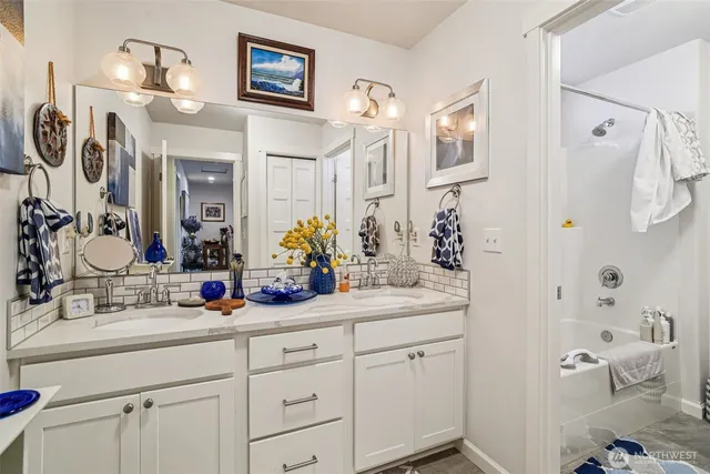 a bathroom with cabinets a sink and mirror