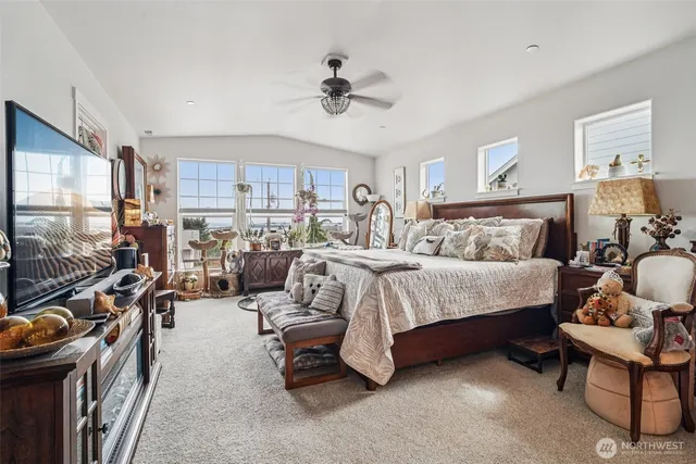 a bedroom with a bed gym equipment and a large window