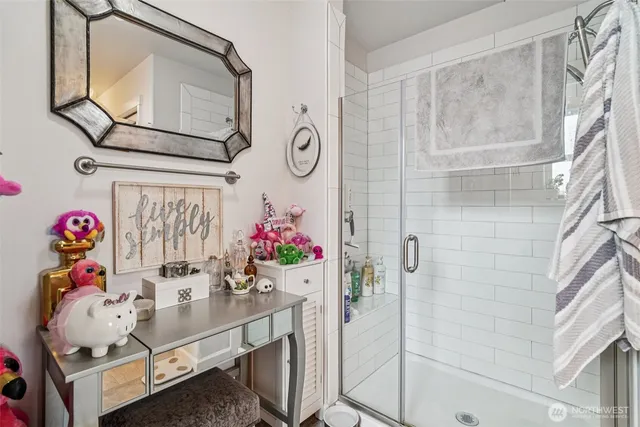 a bathroom with a sink mirror and shower
