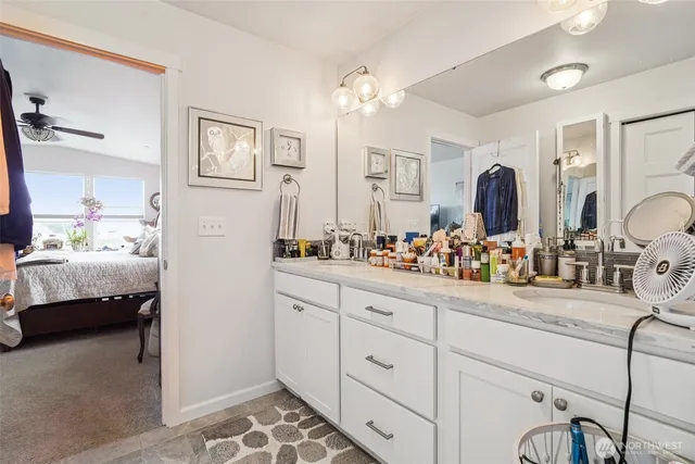 a en suite bathroom with double sink and a mirror
