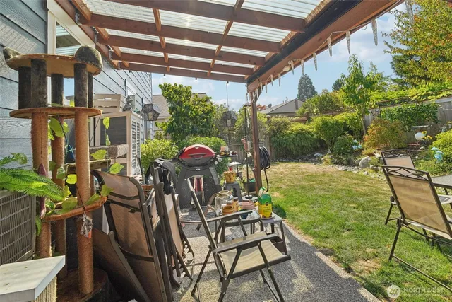 a view of a chairs and table in patio with wooden fence