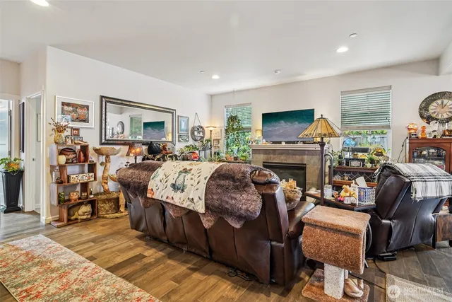 a living room with furniture a fireplace and a flat screen tv