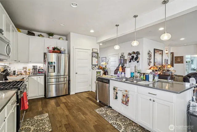 a kitchen with refrigerator and cabinets