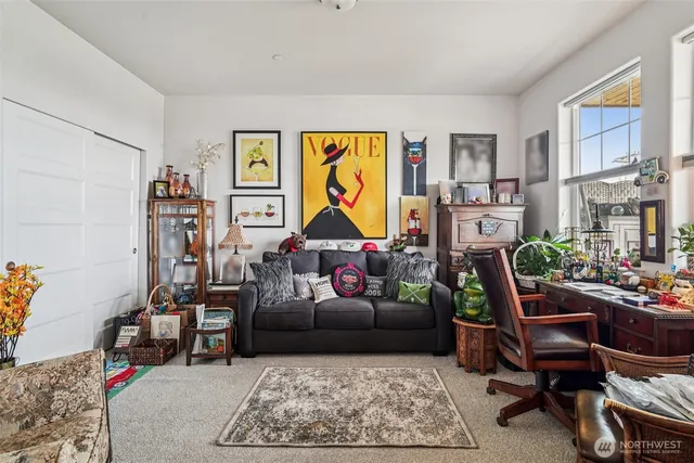 a living room with furniture a couch and paintings on the wall