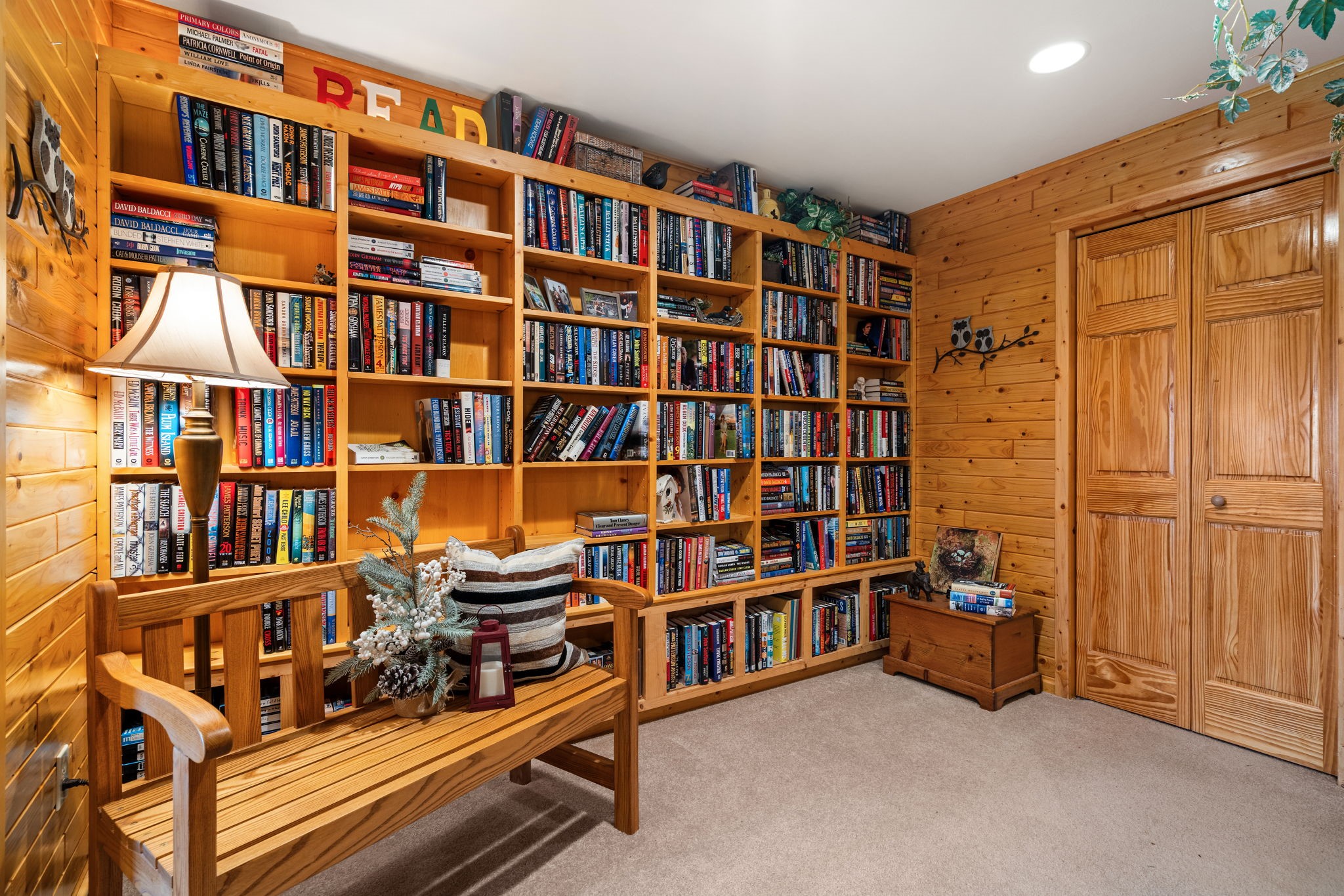 10547 Grandview Lane Hayward, WI 54843 - Photo 26 of 40 As you head down the stairs, a beautiful bookshelf that is included. Closet has access to storage room and utilities/workshop.