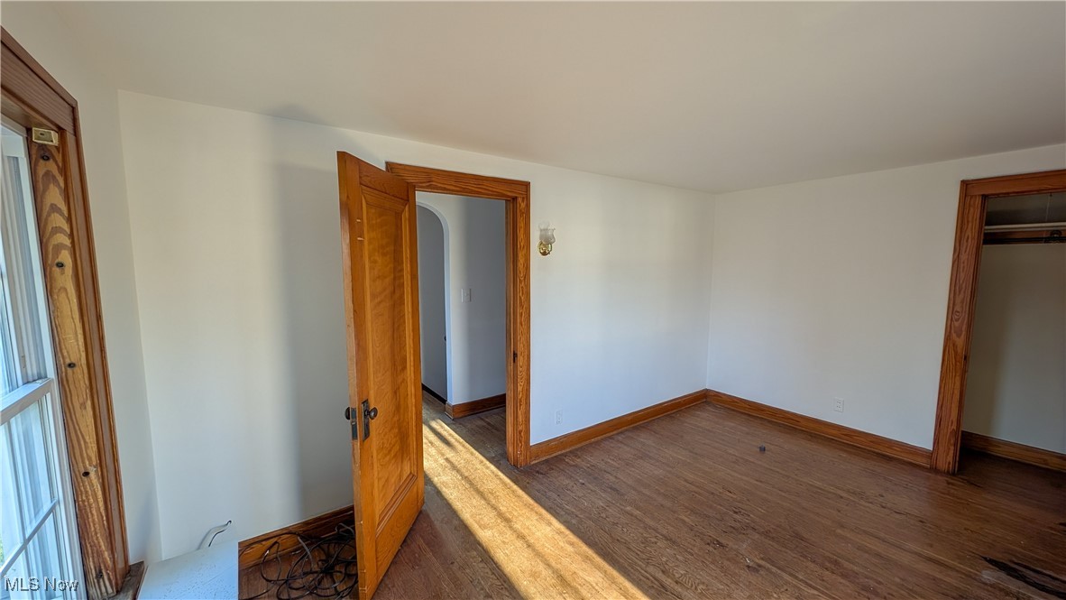 2511 Milan Road Sandusky, OH 44870 - Photo 29 of 40 Unfurnished bedroom featuring dark wood-type flooring and a closet