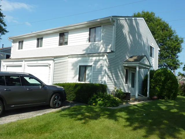 a view of a house with a car park side of the road