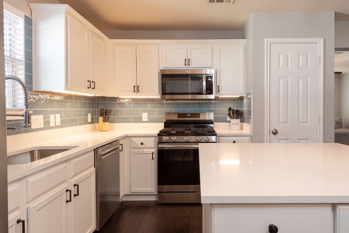 1519 Davis Mountain Loop Cedar Park, TX 78613 - Photo 11 of 39 a kitchen with stainless steel appliances white cabinets and a sink
