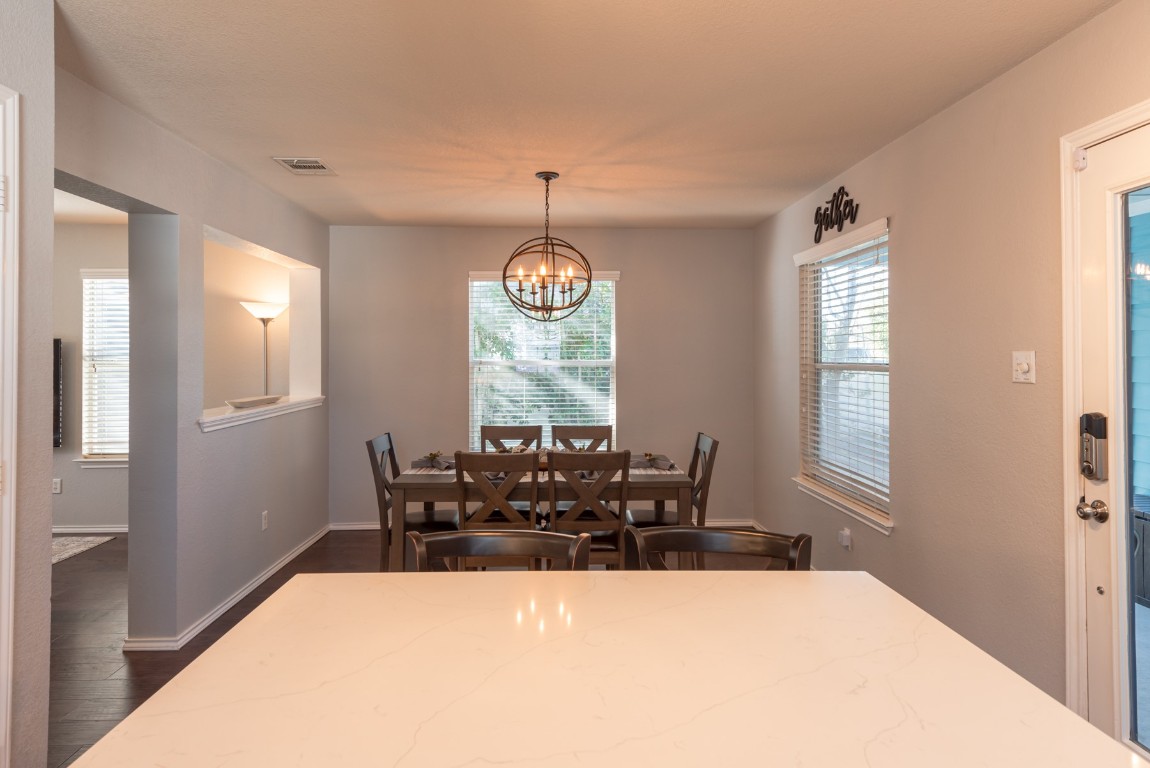 1519 Davis Mountain Loop Cedar Park, TX 78613 - Photo 12 of 39 a view of a dining room with furniture window and wooden floor
