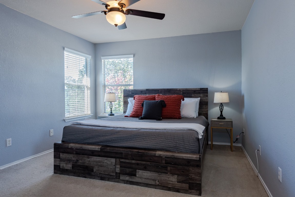 1519 Davis Mountain Loop Cedar Park, TX 78613 - Photo 19 of 39 a bedroom with a bed a chandelier and a window