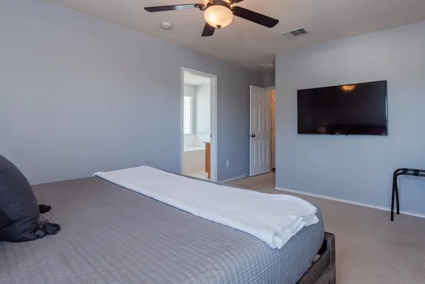 a bedroom with a bed and a lamp