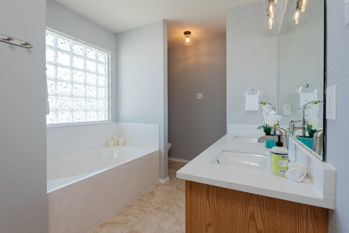 1519 Davis Mountain Loop Cedar Park, TX 78613 - Photo 22 of 39 a bath room with a sink and a bath tub
