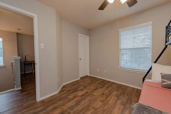 a bedroom with a bed and a ceiling fan