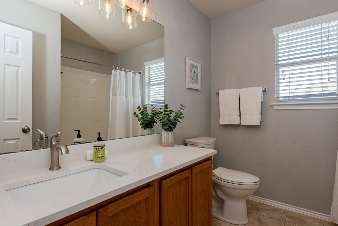 1519 Davis Mountain Loop Cedar Park, TX 78613 - Photo 28 of 39 a bathroom with a sink a toilet and mirror