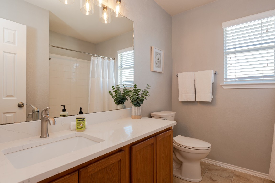 1519 Davis Mountain Loop Cedar Park, TX 78613 - Photo 29 of 39 a bathroom with a sink a toilet and mirror