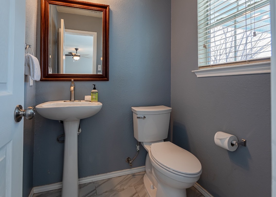 1519 Davis Mountain Loop Cedar Park, TX 78613 - Photo 6 of 39 a bathroom with a toilet sink and mirror