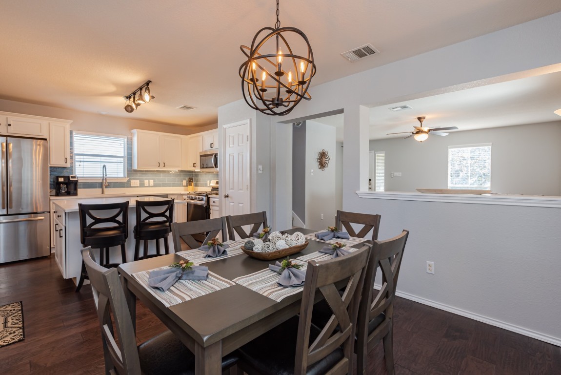 1519 Davis Mountain Loop Cedar Park, TX 78613 - Photo 7 of 39 a view of a dining room with furniture and a chandelier