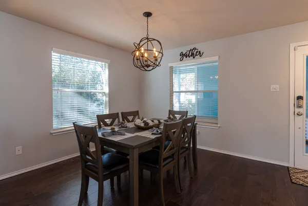 a kitchen with stainless steel appliances a refrigerator a stove a sink dishwasher and a refrigerator with wooden floor
