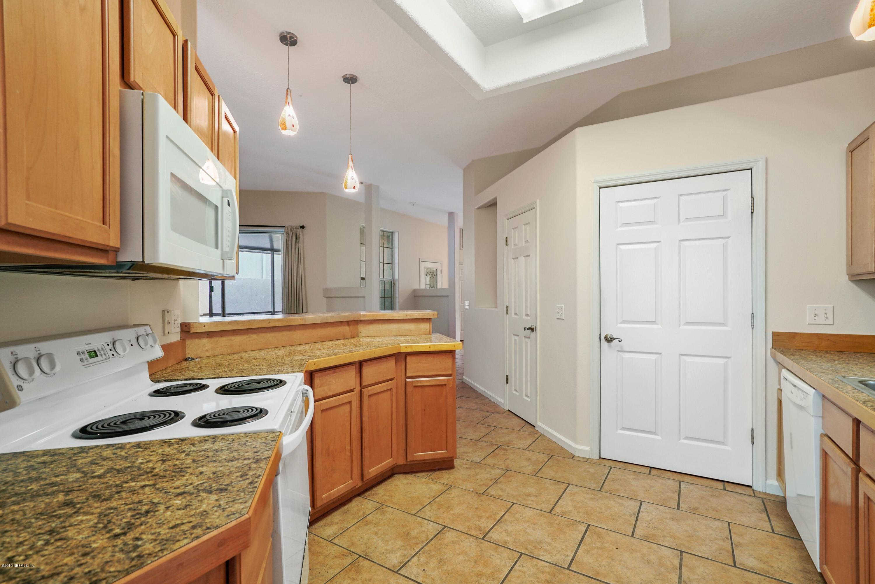 161 Cedar Ridge Circle St. Augustine, FL 32080 - Photo 17 of 31 a kitchen with stainless steel appliances granite countertop a sink stove and cabinets