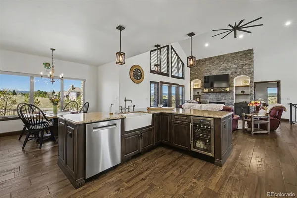 a large kitchen with lots of counter space a sink appliances and dining table