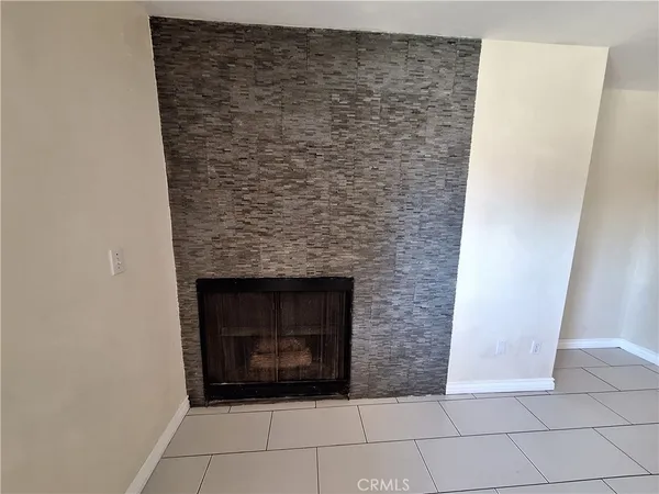 a bedroom with a bed and a large mirror