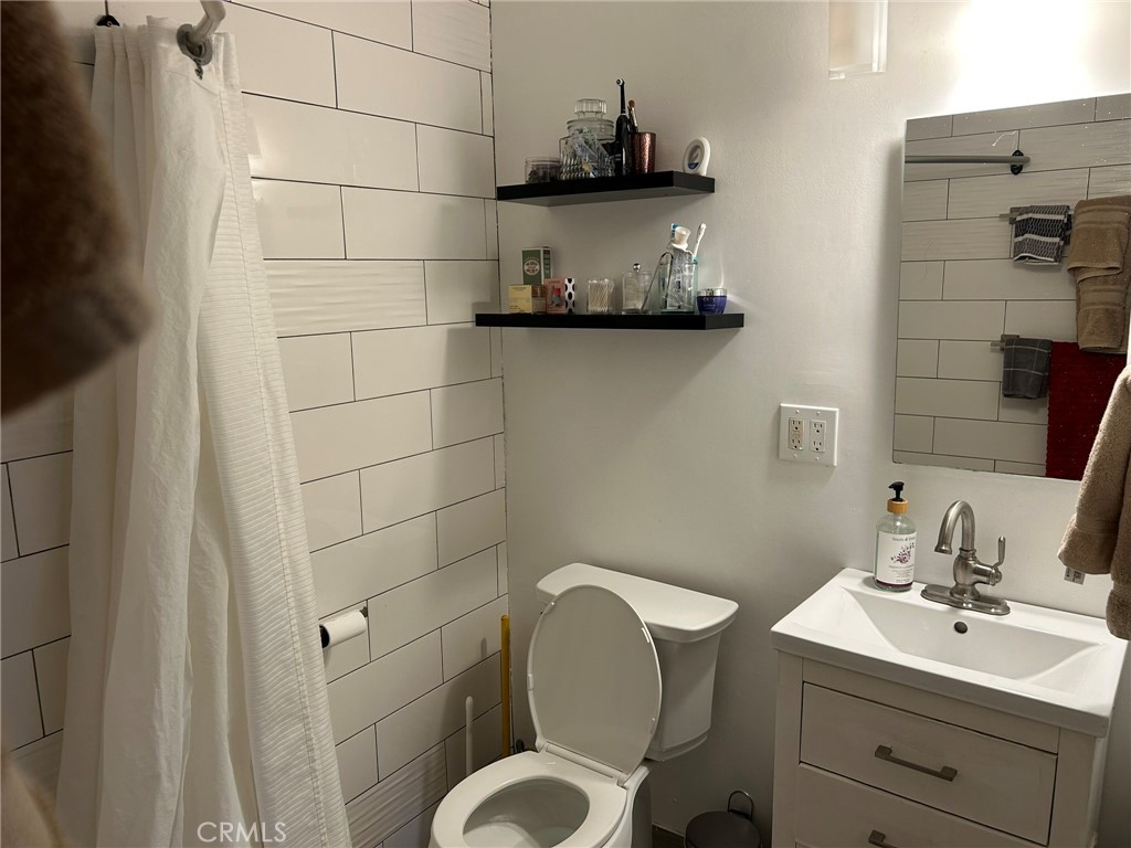 2305 Rockefeller Lane, Unit A Redondo Beach, CA 90278 - Photo 22 of 53 a bathroom with a toilet a sink and mirror