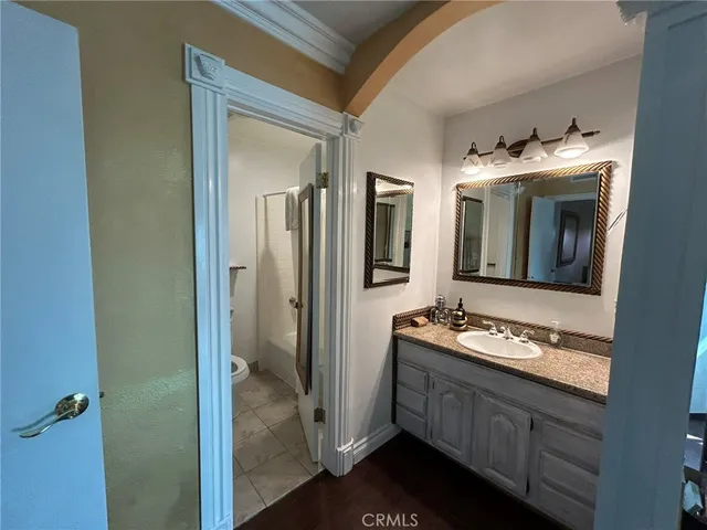 a bathroom with a granite countertop sink and a mirror