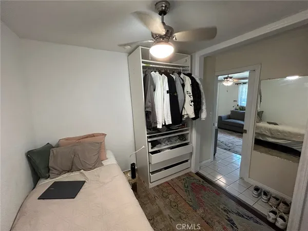 a room with wooden floor and a ceiling fan