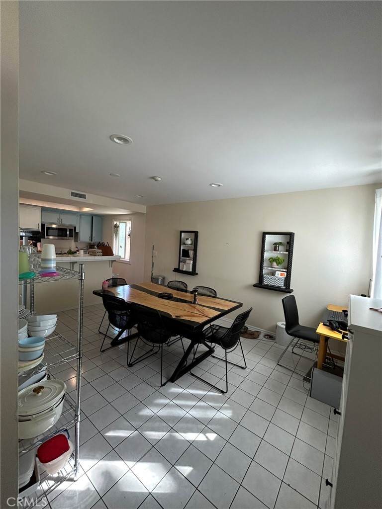2305 Rockefeller Lane, Unit A Redondo Beach, CA 90278 - Photo 36 of 53 a living room with furniture a rug and a lamp