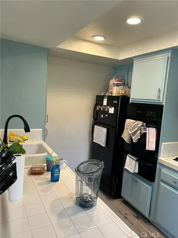 a open kitchen with a sink appliances and wooden floor