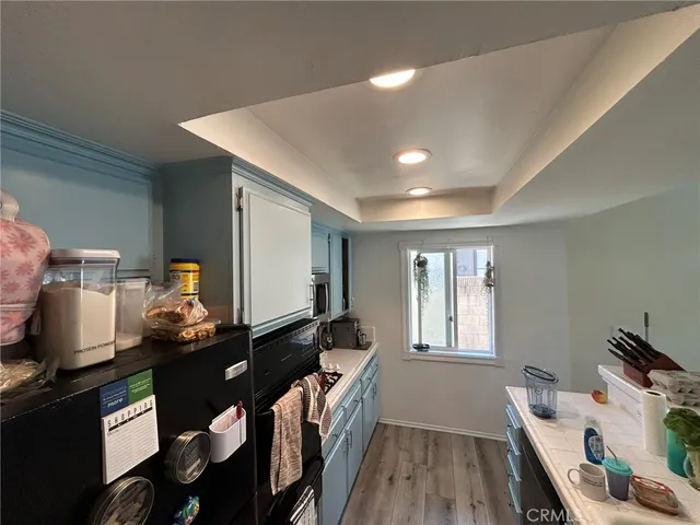 a living room with furniture a flat screen tv and white walls
